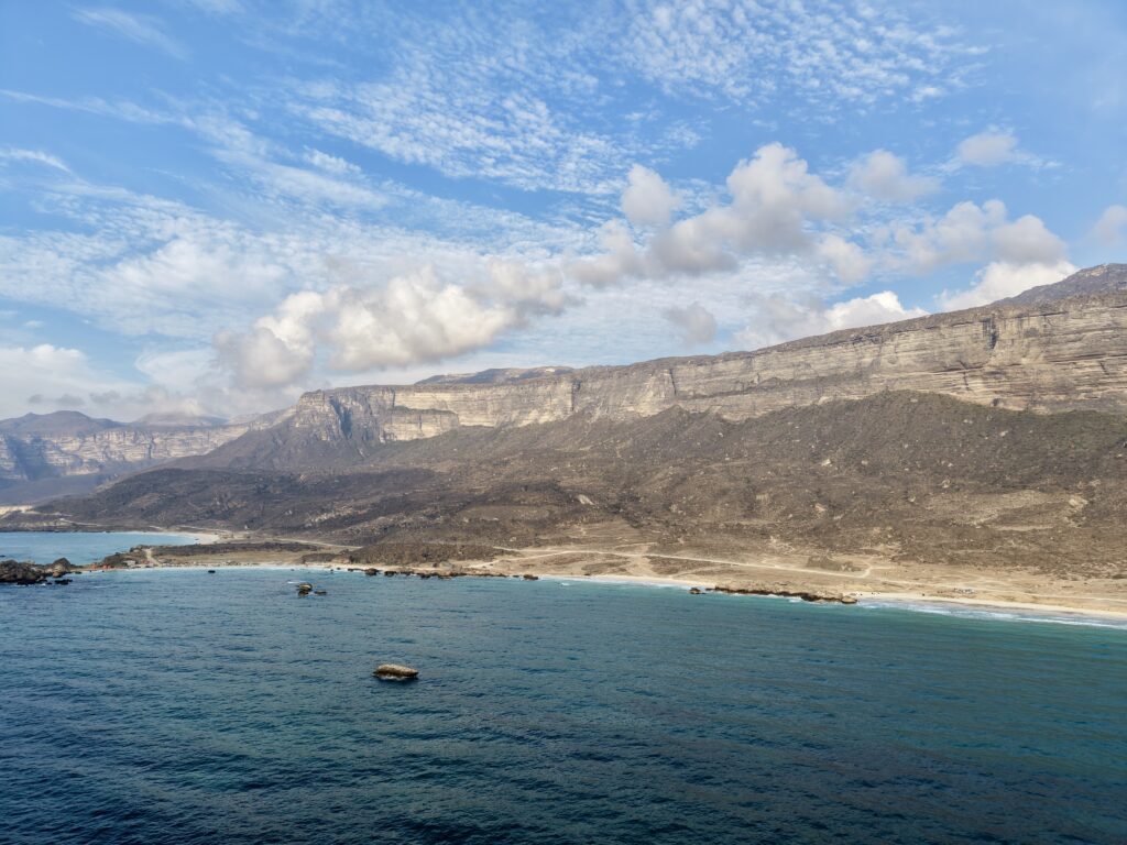 Al Fazayah Beach Salalah Oman panoramic coastline turquoise sea mountains scenic view Dhofar
