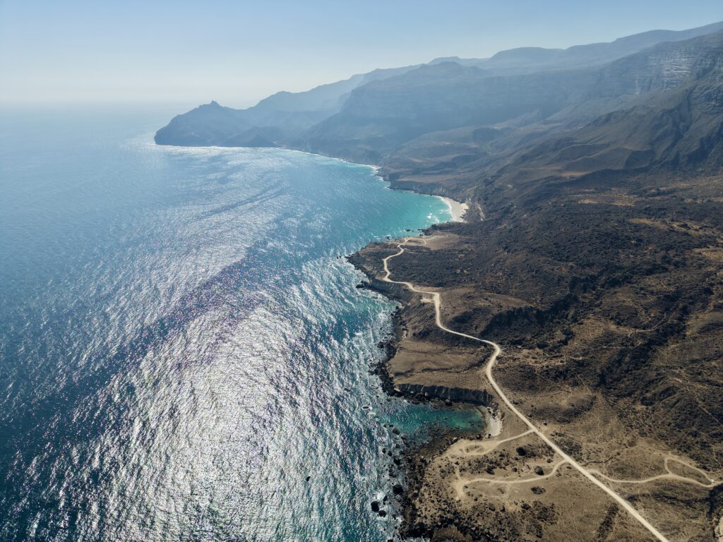 Al Fazayah Beach Salalah Oman turquoise water hidden beach swimming kayaking relaxation coastal cliffs