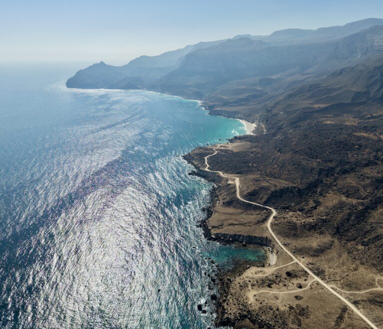 Al Fazayah Beach Salalah Oman turquoise water hidden beach swimming kayaking relaxation coastal cliffs