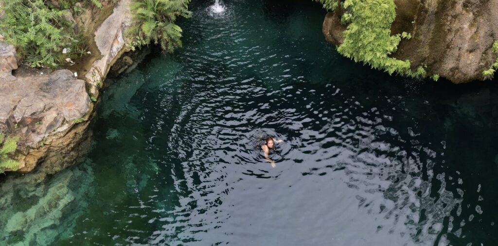 Drone view of crystal clear waterfall pool swimming experience in Salalah Oman – adventure hiking trips
