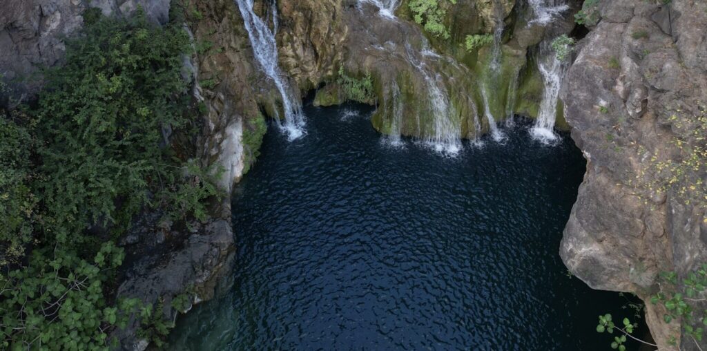 Hidden natural waterfall pool in Salalah Oman – hiking and nature adventure trips