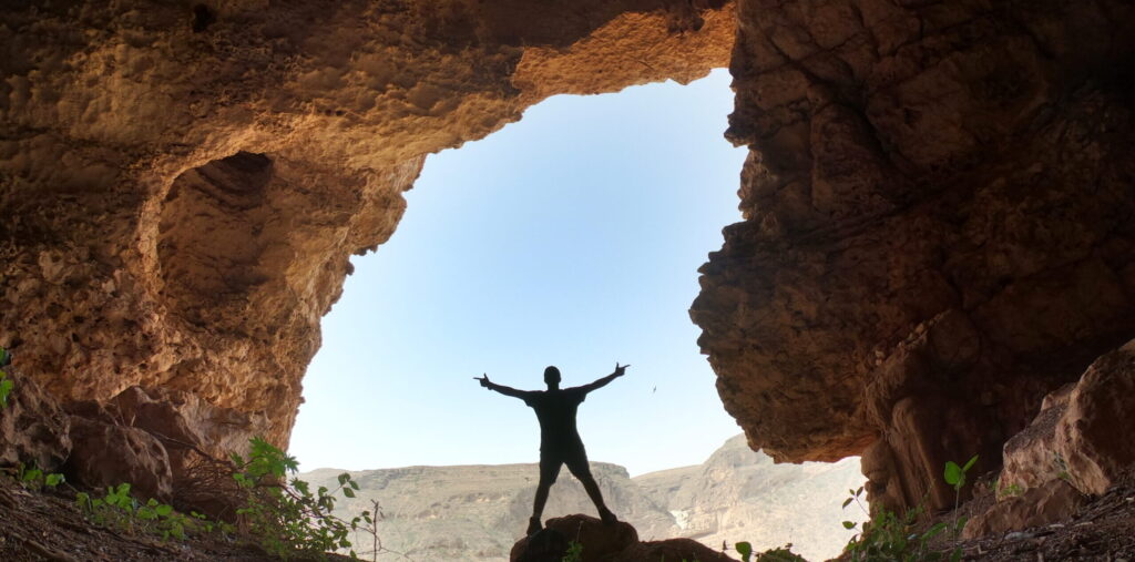 Hidden cave hiking experience in Salalah Oman with mountain view and outdoor adventure