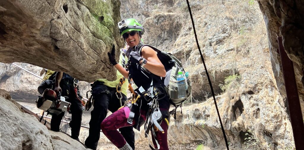 Abseiling at Tawi Atair Sinkhole in Salalah Oman during guided rock climbing and adventure tour