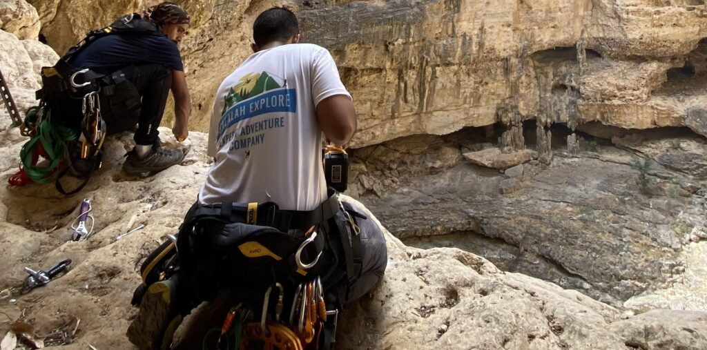 Salalah Explore team inside Tawi Atair Sinkhole in Oman preparing climbing and abseiling equipment