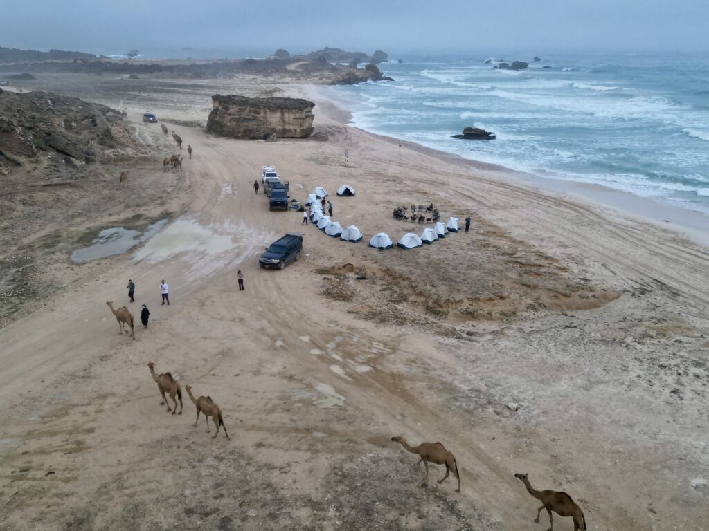 Hidden beach camping in Salalah, Oman with ocean view, luxury tents and camels