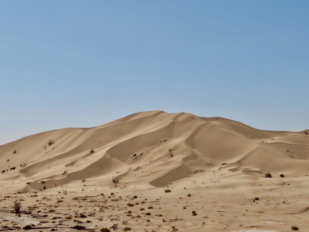 Golden sand dunes in Rub Al Khali desert Oman during desert camping and adventure tour experience
