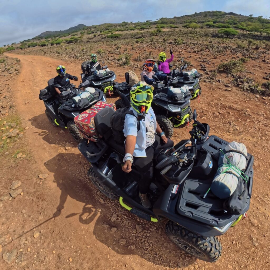 Riders enjoying a guided quad bike camping adventure in the mountains of Salalah, Oman.
